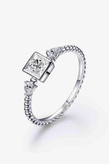 a white gold ring with a princess cut diamond