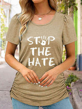 a woman wearing a stop the hate t - shirt