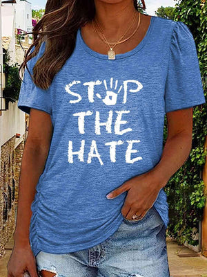 a woman wearing a blue shirt that says stop the hate