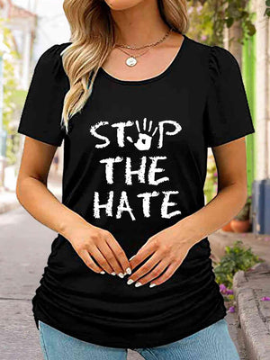 a woman wearing a black shirt that says stop the hate