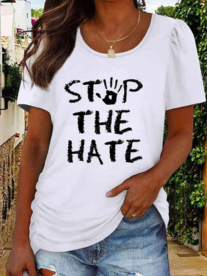 a woman wearing a white shirt that says stop the hate