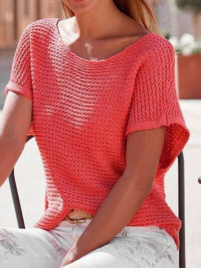 a woman sitting in a chair wearing a red sweater