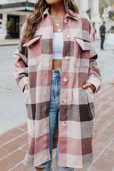 a woman wearing a pink plaid coat and jeans