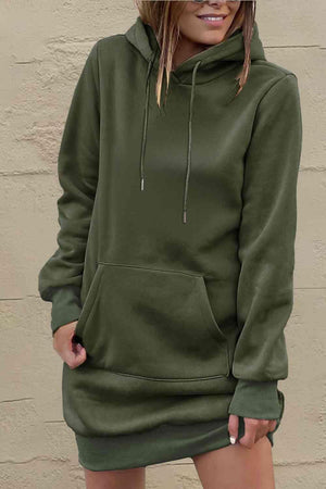 a woman wearing a green hoodie and shorts