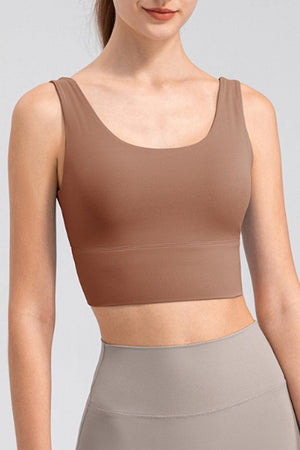 a woman in a tan sports bra top