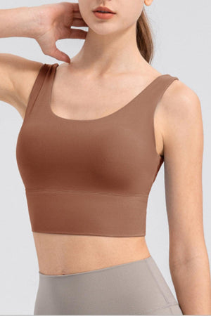 a woman in a brown sports bra top