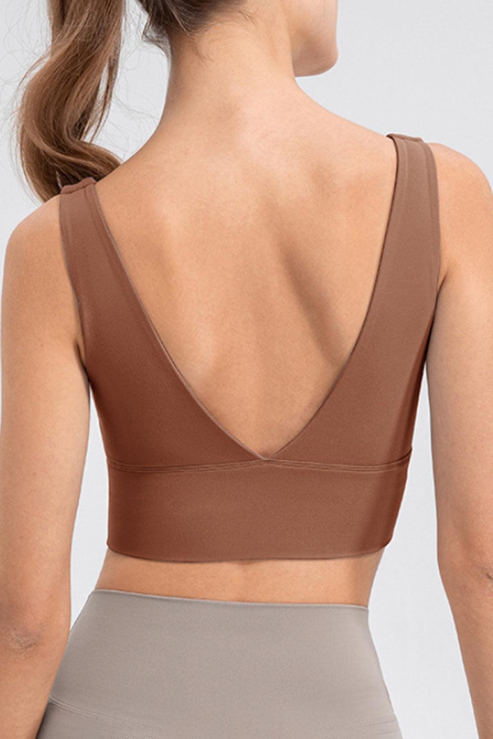 a woman wearing a brown sports bra top