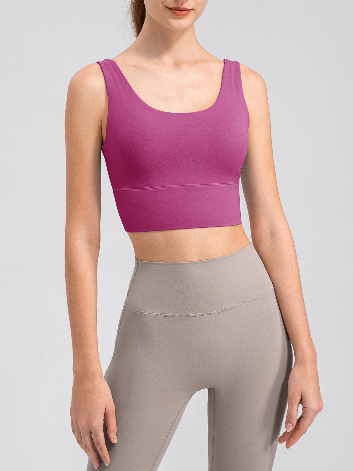 a woman in a pink top and grey leggings