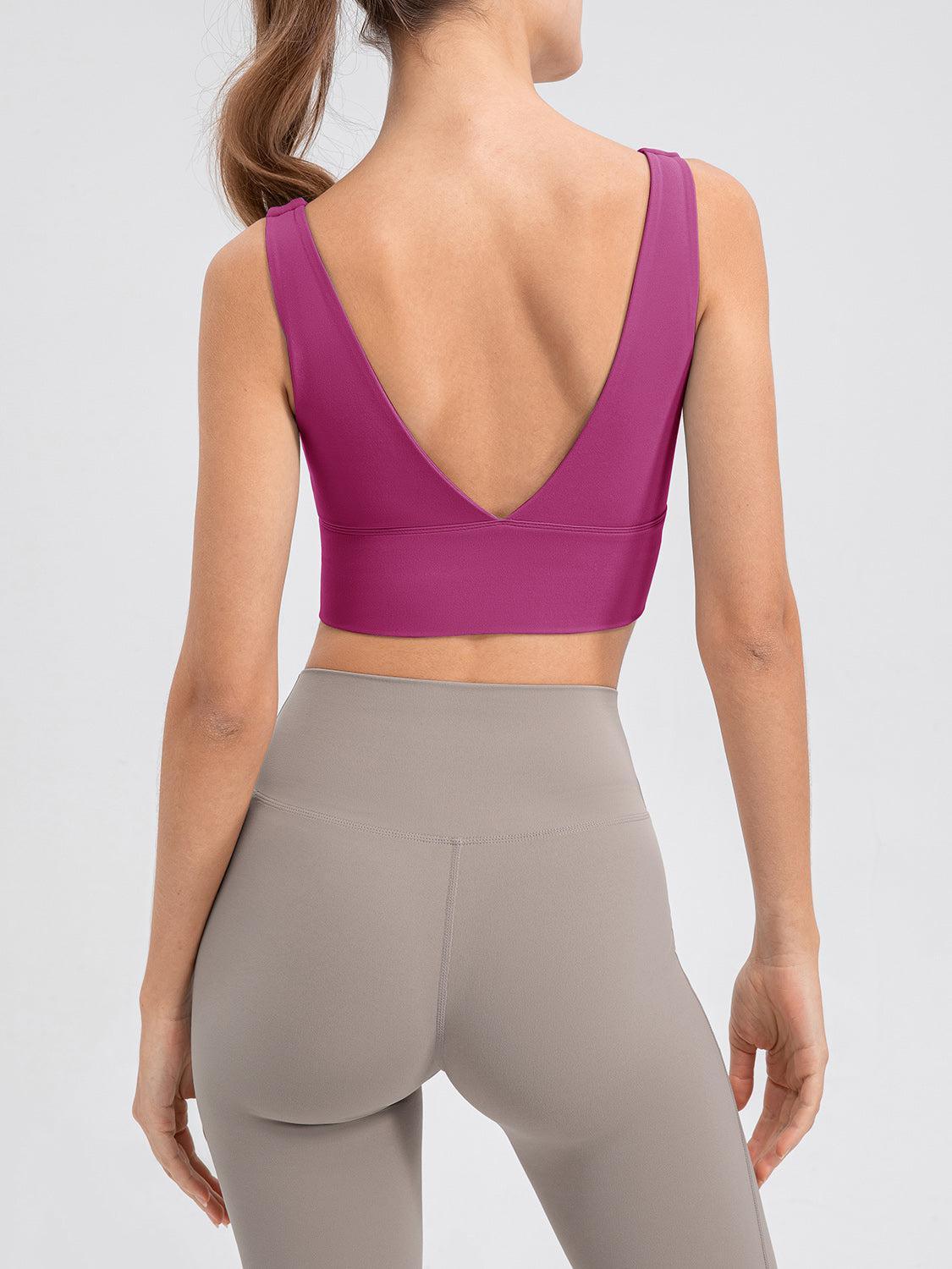 the back of a woman wearing a purple sports bra