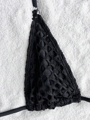 a black bralet laying on top of a pile of snow