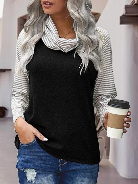 a woman holding a cup of coffee and wearing a black top