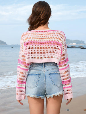 a woman standing on a beach next to the ocean