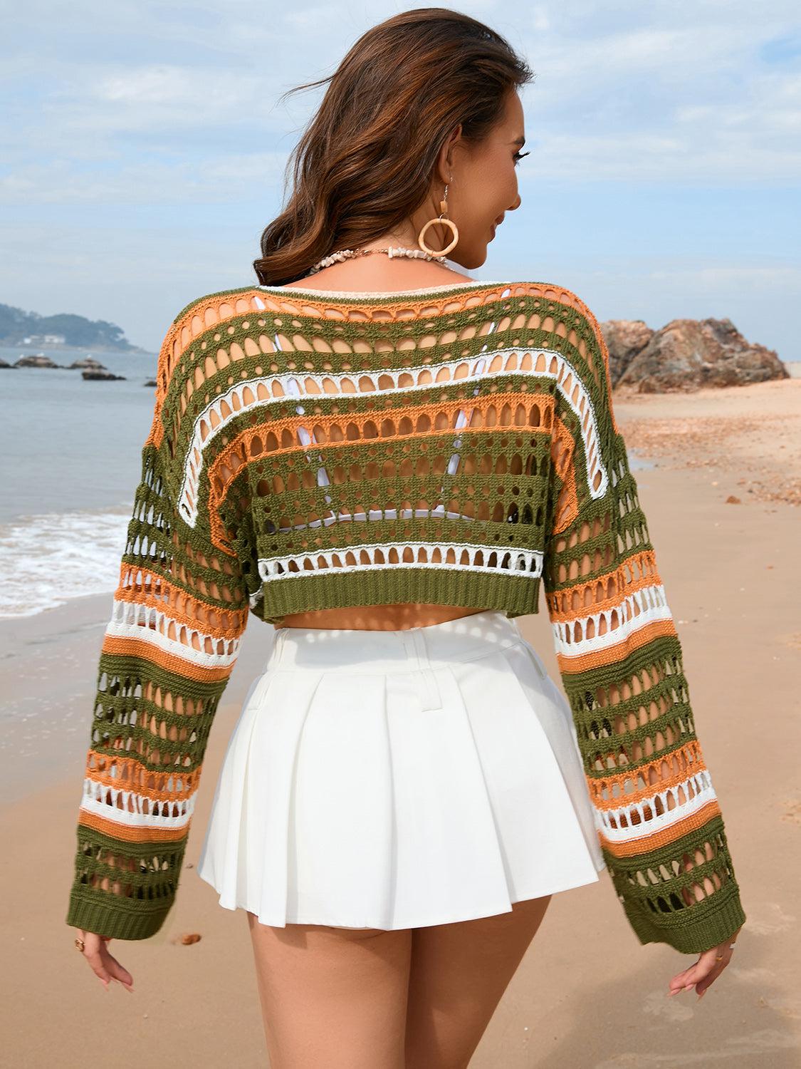 a woman standing on a beach next to the ocean