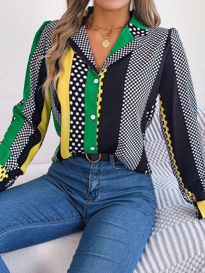 a woman sitting on a couch wearing a colorful shirt