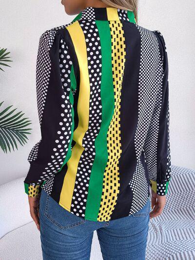 a woman wearing a colorful shirt and jeans