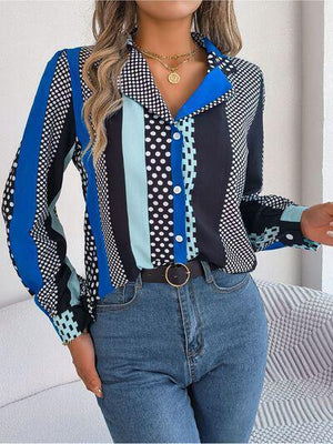 a woman wearing a blue and black shirt and jeans