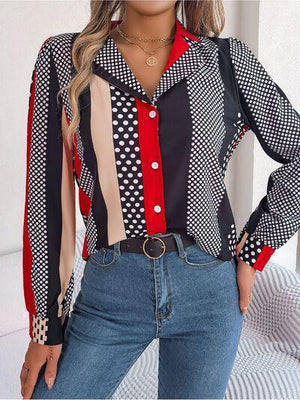 a woman wearing a colorful shirt and jeans