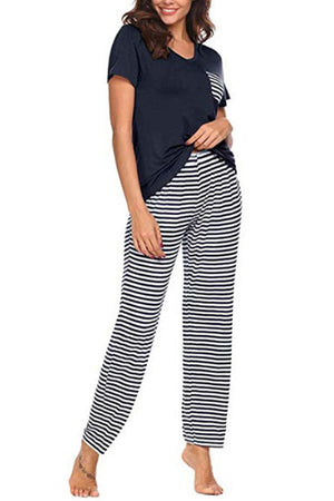 a woman wearing a black and white striped pajama set