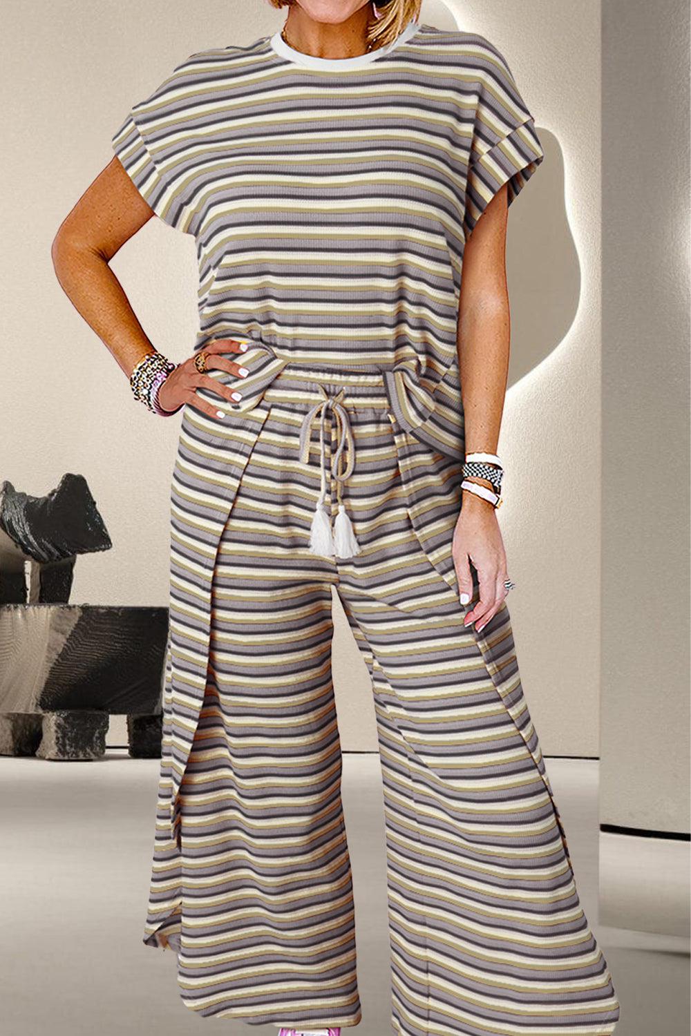 a woman in a striped jumpsuit posing for a picture