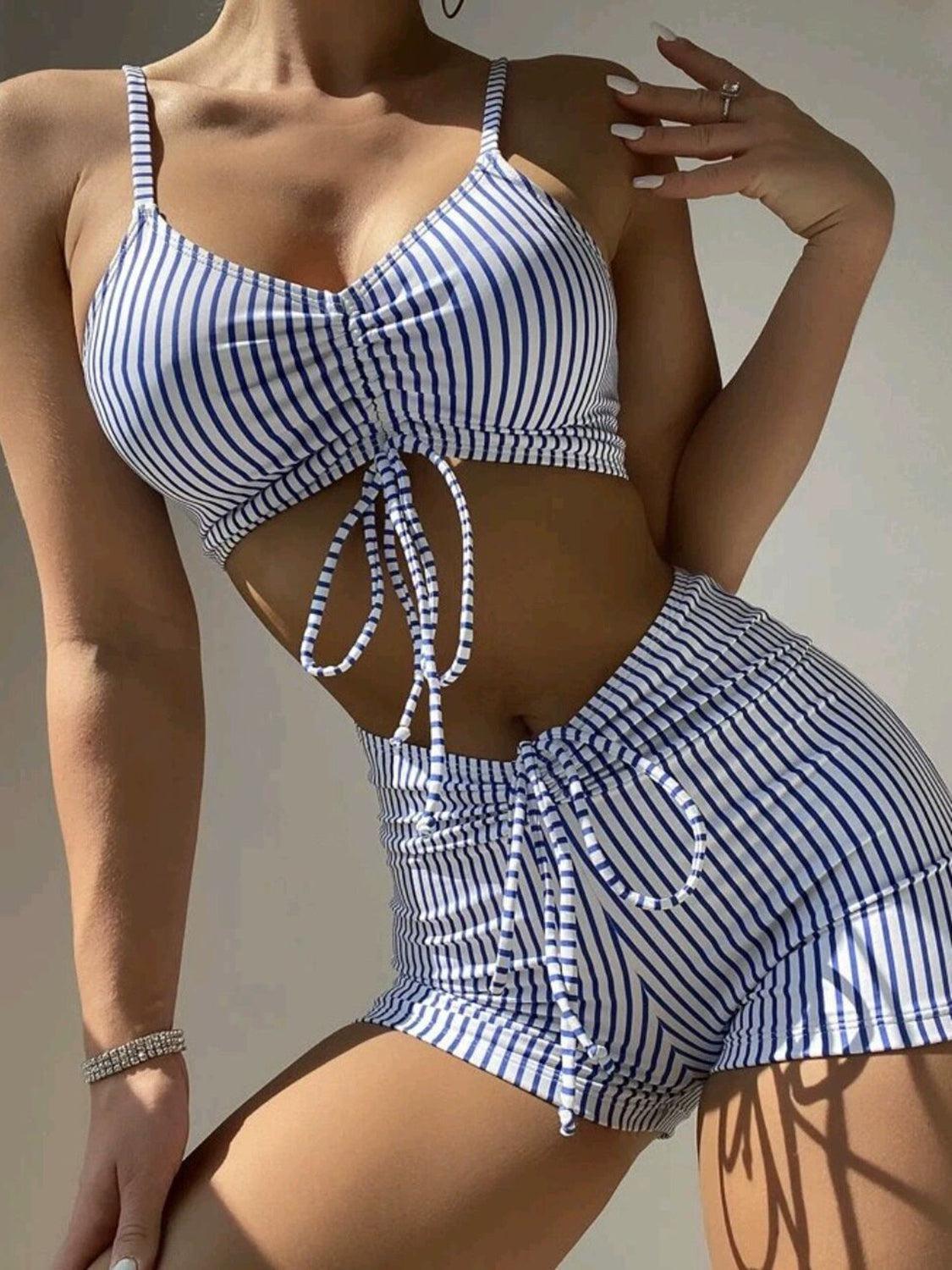 a woman in a blue and white striped bathing suit