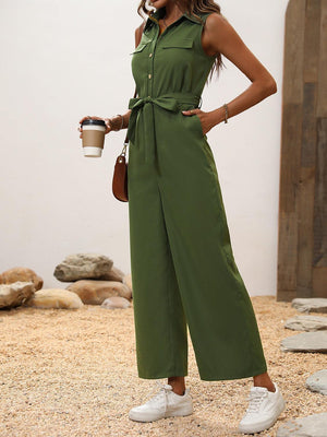 a woman in a green jumpsuit holding a cup of coffee