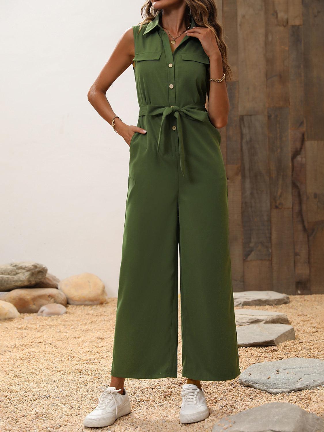a woman wearing a green jumpsuit and white sneakers