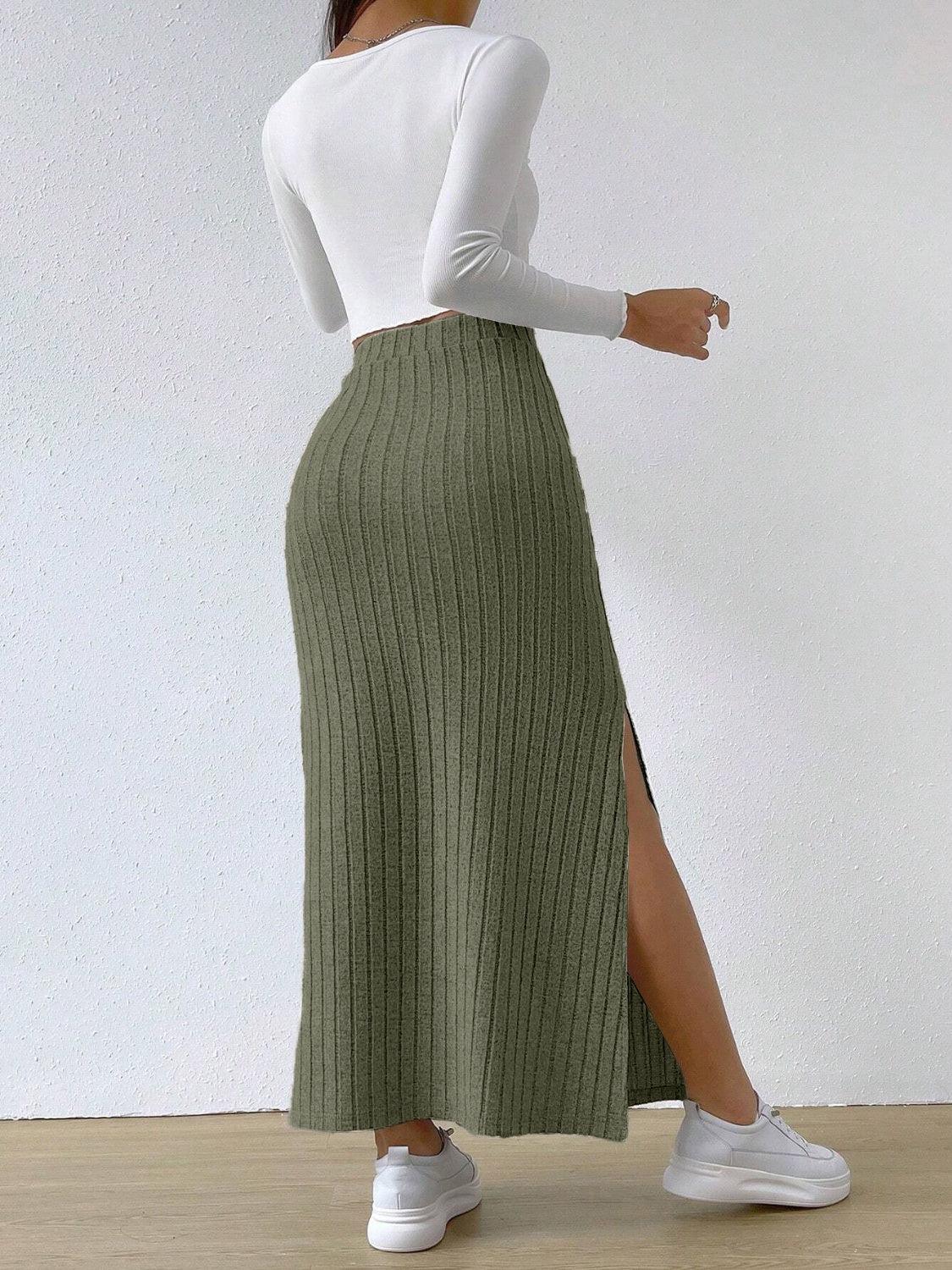 a woman in a white top and a green skirt