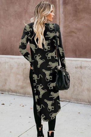 a woman wearing a black and gold leopard print dress