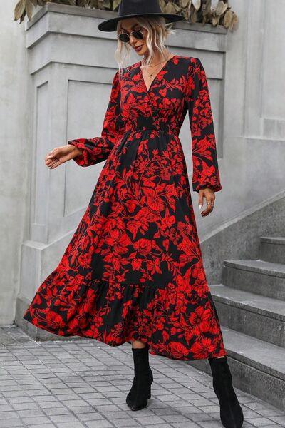 a woman wearing a red and black floral print dress