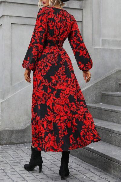 a woman wearing a red and black floral print dress