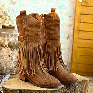 a pair of brown boots with fringes on them