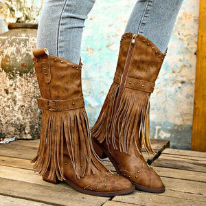 a pair of brown boots with fringes on them