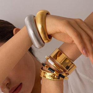 a woman with a stack of bracelets on her arm