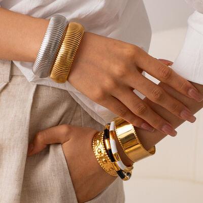 a close up of a person wearing two different bracelets