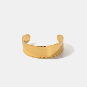 a gold cuff with a curved edge