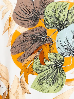 a close up of a shirt with leaves on it