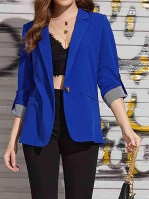 a woman wearing a blue blazer and black pants