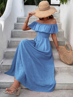 a woman wearing a blue dress and straw hat