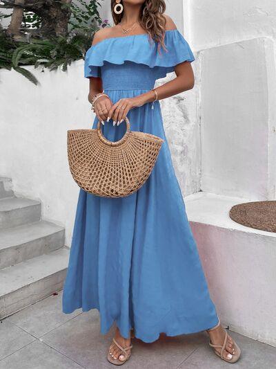 a woman in a blue dress holding a straw bag
