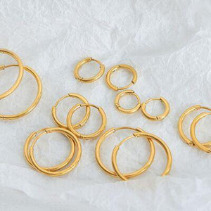 a bunch of gold colored metal rings on a white background