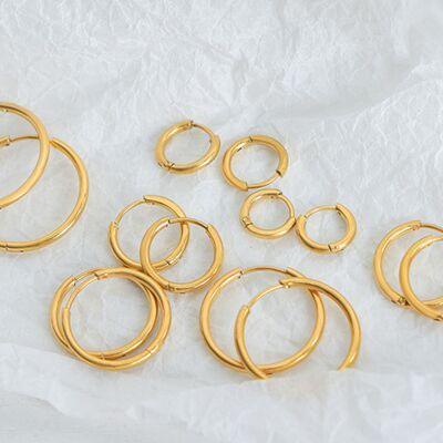 a bunch of gold colored metal rings on a white background