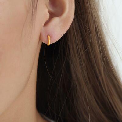 a close up of a person wearing a pair of earrings