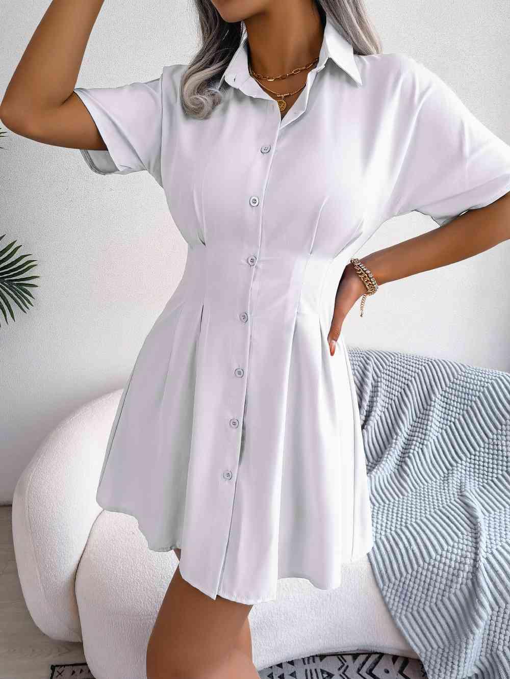 a woman wearing a white shirt dress