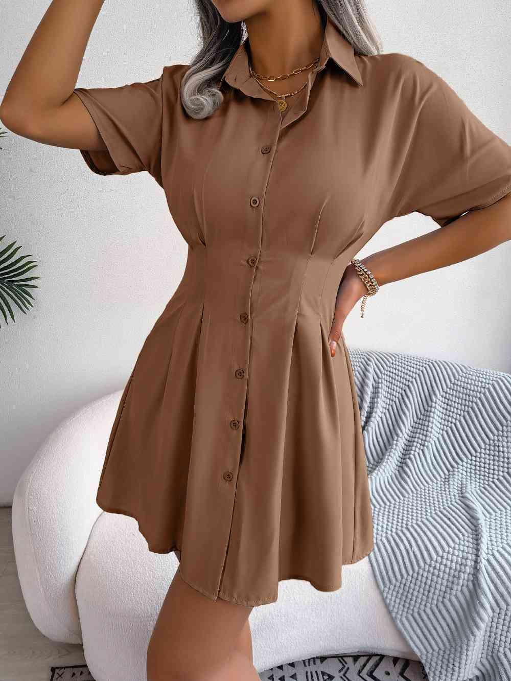 a woman wearing a brown shirt dress