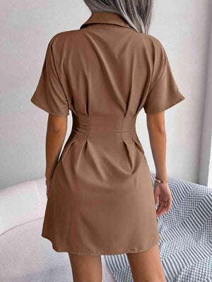 a woman wearing a brown shirt dress