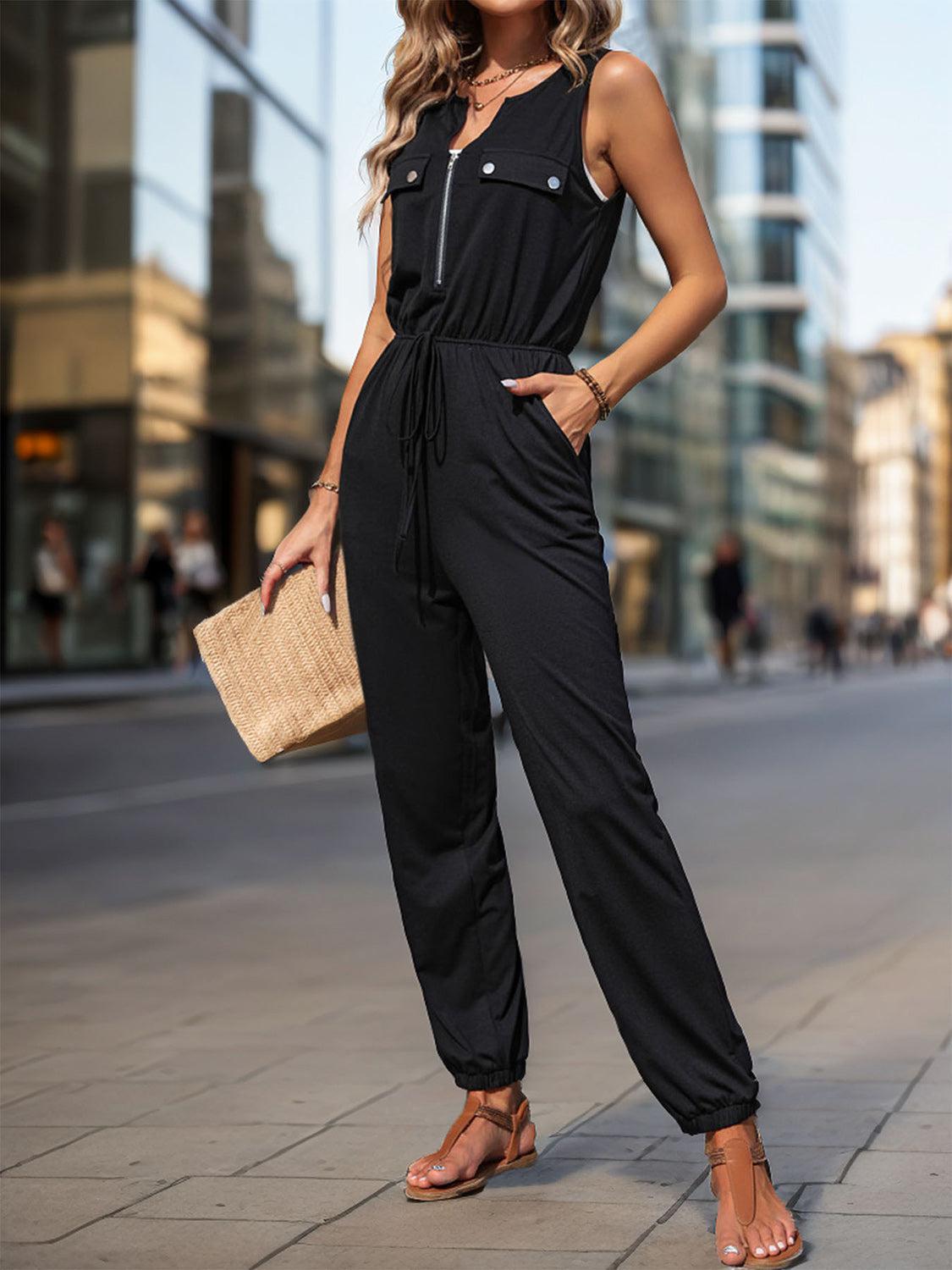 a woman in a black jumpsuit posing for a picture