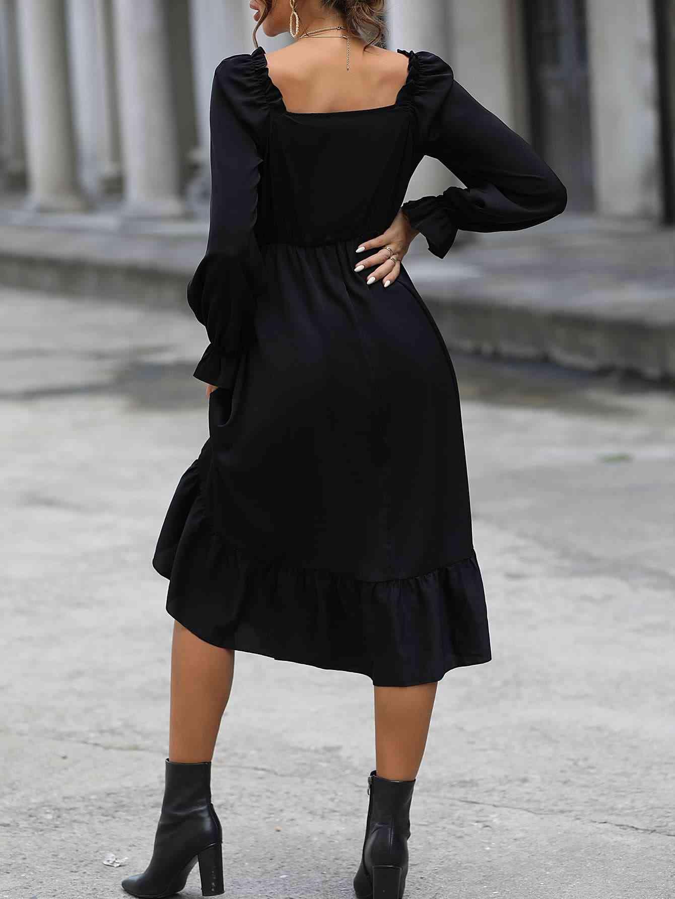 a woman wearing a black dress and boots