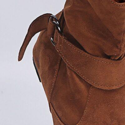 a close up of a person's brown boots