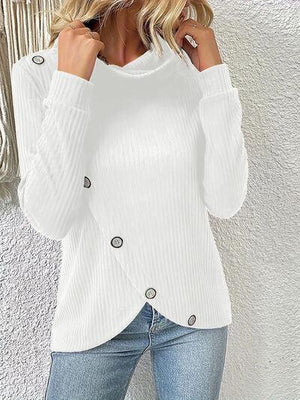 a woman wearing a white sweater and jeans