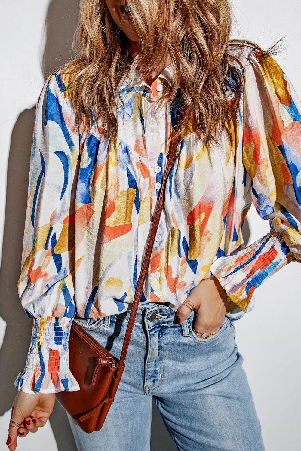 a woman wearing a colorful shirt and jeans